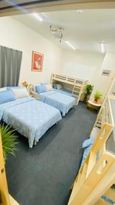 a bedroom with two beds and two bunk beds at THE CAMILLE PLACE Tokyo Edogawa has direct access to Akihabara and Shinjuku, with convenient transportation and free WiFi in Tokyo