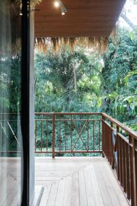 an open balcony with a view of the forest at Ningmas Escape by Sidhi Hospitality Experiences in Ubud +11 photos