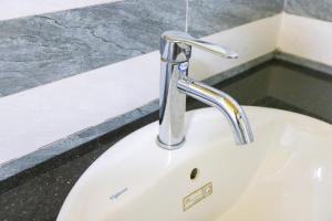 a white sink with a chrome faucet in a bathroom at Ninh Binh Footprint Homestay in Ninh Binh +33 photos
