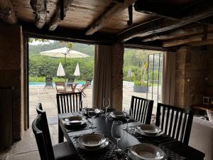 a dining room table with chairs and a table with wine glasses at Casa de Rompecias in Vizela +56 photos