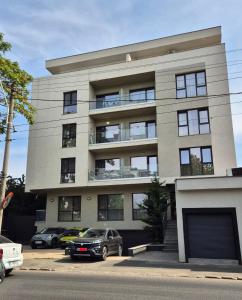 a building with cars parked in front of it at Antiaeriana Sunhouse in Bucharest