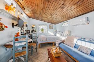 un soggiorno con un divano blu e un letto di Cozy Tiny Home Retreat on Shenandoah Valley Farm cabin a Mount Jackson