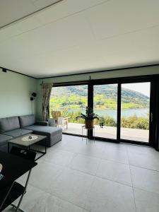 a living room with a couch and a large window at Olden Apartment with Panorama view in Olden +5 photos