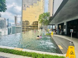 people in a swimming pool on top of a building at Axon Residence KLCC At Kuala lumpur in Kuala Lumpur