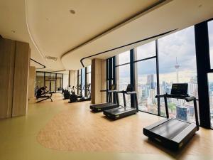 a gym with treadmills and a view of the city at Axon Residence KLCC At Kuala lumpur in Kuala Lumpur
