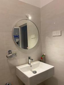 a bathroom with a white sink and a mirror at Unawatuna House in Unawatuna +26 photos
