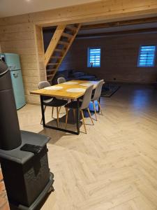 a dining room with a table and chairs in a room at Siedlisko pod brzozami in Bielsk Podlaski