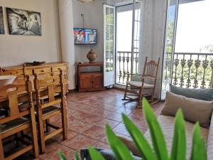 a living room with a table and chairs at Mirador de la Campiña in Cazorla