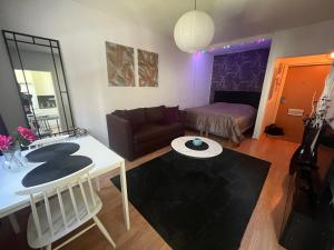 a living room with a table and a couch at Huoneisto kaupungissa Joensuu in Joensuu