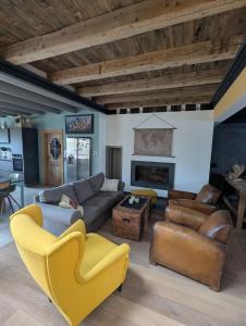 a living room with a couch and chairs and a fireplace at Maison à la campagne 14 couchages - Jardin - Bain nordique 