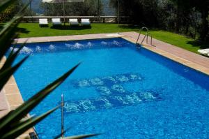 a large swimming pool with blue water in a yard at Balcón de Válor in Válor +100 photos