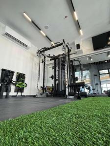 a room with a gym with a green carpet at Dorm in Katipunan - Upper Bunk Bed in Manila
