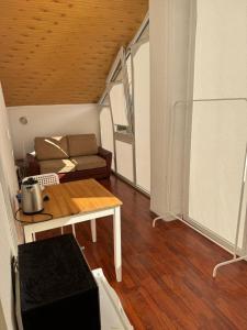 a living room with a couch and a table at Saules namu kambariukas in Palanga