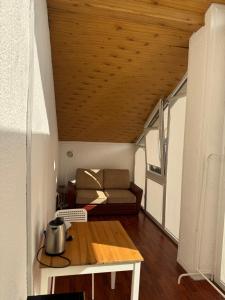 a living room with a couch and a table at Saules namu kambariukas in Palanga