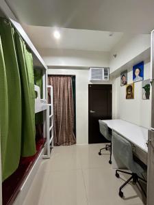 a room with a bed and a desk in a room at Dorm in Katipunan - Upper Bunk Bed in Manila