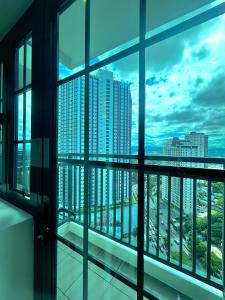 a view of a city skyline from a window at Dorm in Katipunan - Upper Bunk Bed in Manila