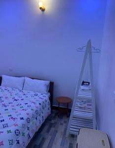 a bedroom with a bed with a ladder next to it at Freetime zone in Dar es Salaam