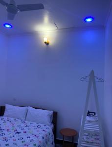 a room with a bed with a blue light at Freetime zone in Dar es Salaam