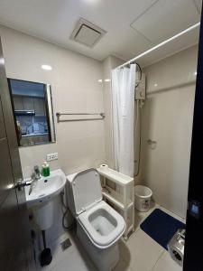 a bathroom with a toilet and a sink at Dorm in Katipunan - Upper Bunk Bed in Manila +17 photos