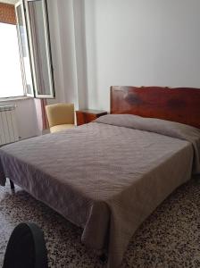 a bedroom with a large bed and a window at MARI Home in Cosenza