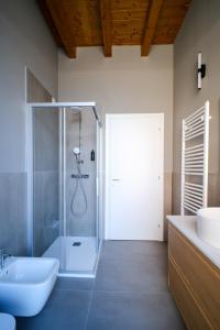 a bathroom with a shower and a toilet and a sink at Premier Stay The Tower - Bernina Experience in Tirano