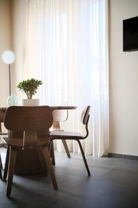 a dining room with a table and chairs and a plant at Premier Stay The Tower - Bernina Experience in Tirano +13 photos
