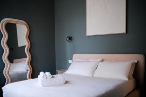 a bedroom with a bed with two towels on it at The Tower Premium Apartment - Beams & Views - 3 Min Walk to Bernina Express & Station in Tirano