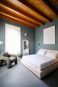 a bedroom with a large bed and a chair at Premier Stay The Tower - Bernina Experience in Tirano