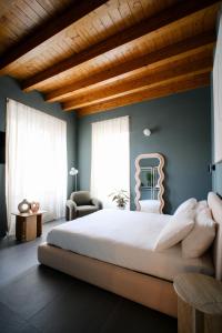 a bedroom with a large bed with a wooden ceiling at Premier Stay The Tower - Bernina Experience in Tirano