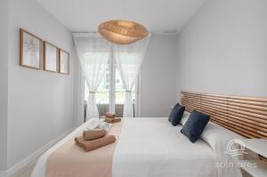 a bedroom with a large bed with a large window at Los Camaleones EXCELLENT & SOLMARES in Isla Canela +165 photos