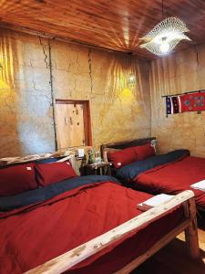 a bedroom with two beds with red pillows at Amazing Lô Lô Chải Homestay in Dồng Văn +8 photos