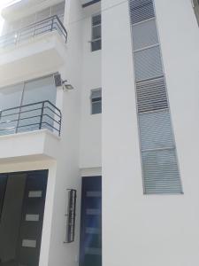 a white building with a door and a balcony at Apartamento lindo con Jacuzzi in Villeta