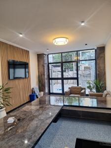 a living room with a glass table and a couch at Point Central Hotel in Addis Ababa