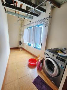 a washing machine in a room with a window at Thương Chánh Homestay in Phan Thiet +11 photos