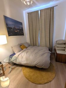 a bedroom with a bed and a large window at Cosy Apartment close to Oktoberfest, best infrastructure, parking included in Munich