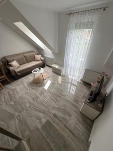 a living room with a couch and a table at Marót Apartman in Keszthely