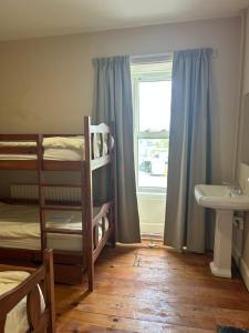 a room with two bunk beds and a window at IEC Campus for Groups in Kanturk