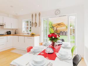 a kitchen and dining room with a table and chairs at Beautiful 4 bedrooms house private parking & garden 7 min from tube in London