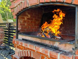 a brick oven with a fire in it at Cabana Plapumioara in Crucea