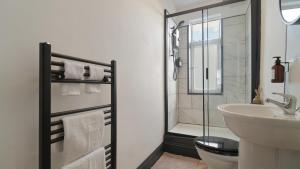 a bathroom with a sink and a toilet and a shower at Cozy Sheffield Retreat 3BR, 2BA, Parking & WiFi in Sheffield