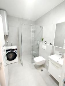 a bathroom with a shower toilet and a sink at Urban Elegance Studio & SPA in Niš +31 photos
