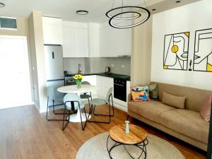 a living room with a couch and a table at Urban Elegance Studio & SPA in Niš