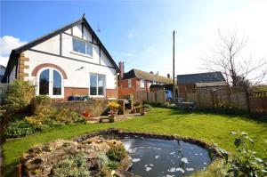 a house with a pond in the yard at Hawthorn Valley Views in Wroxall