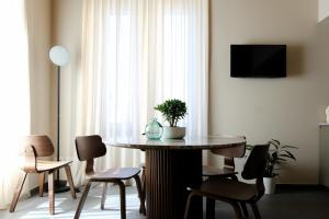 a table and chairs in a room with a window at The Tower Premium Apartment - Beams & Views - 3 Min Walk to Bernina Express & Station in Tirano