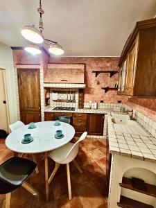 a kitchen with a white table and chairs in it at Suite Santa Caterina in Altamura