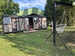 a yurt with a swing in a yard at Wagonlit 27 in Civières