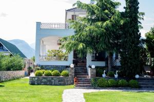 a house with a tree in the front yard at Villa with Private Pool by the coast of Olympus in Leptokarya