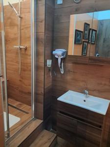a bathroom with a shower and a sink at Fusion Homestay Accommodation in Mosta