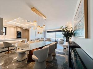 a dining room and living room with a table and chairs at FOS Luxury Apartment with View of Nafplio in Nafplio