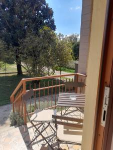 a porch with a table and chairs on a deck at Casa La V G in Almese +12 photos